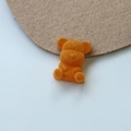 Detailed view of an orange flocked teddy bear charm with a soft velvet texture for DIY crafts - Orange