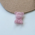 Macro shot of pink flocked teddy bear DIY accessory with soft textured velvet surface - Pink
