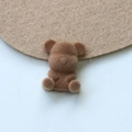 Macro detail of a brown flocked teddy bear patch for DIY jewelry and accessories - Light Coffee