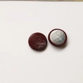 Macro detail of round dark brown snake pattern leather buttons with silver metal backing - Round / Burgundy