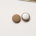 Detailed macro view of round brown velvet fabric button with silver metal backing - Round / Khaki