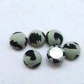 Close-up of light green leopard print fabric buttons for DIY handmade jewelry crafts - Green Leopard Pattern Style