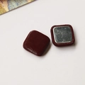 Detail view of square magnetic buttons with deep wine red leather texture and metal back - Square / Burgundy