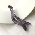 Close-up of matte purple banana hair clip with internal interlocking teeth for secure grip - Dark Purple