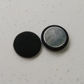 Detail of round magnetic hijab clip with black textured fabric and silver metal base - Black