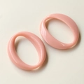 Close-up of pink oval acrylic pendant accessories with smooth polished resin finish - Pink