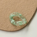 Close-up of clear acrylic link with green ink splatter pattern for DIY jewelry design - Green