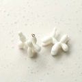 Detail of white resin balloon dog charms with gold rings for DIY jewelry making - Milk White