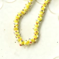 Macro shot of yellow lampwork glass beads with colorful dots for DIY jewelry making - 1 Piece / Yellow