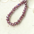 Macro shot of purple translucent glass beads with blue and white evil eye pattern - 1 Piece / Purple