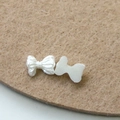 Detailed front and back view of white faux pearl bow charms for DIY nail art and crafts - Exquisite Relief Style (5)