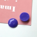 Detailed view of glossy purple resin beads with marble texture for DIY jewelry making - Purple
