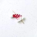 Detailed view of handmade glass Christmas hat bead with white polka dots for jewelry making - Christmas Hat
