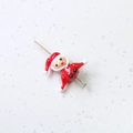 Macro shot of cute red glass Santa bead with gold pin for DIY jewelry making - Santa Claus