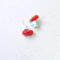 Detail view of handmade red and white Christmas boot charms with ceramic finish - Red and White Enamel Christmas Sock