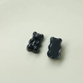 Detail view of two black resin gummy bear charms showing front details and flat back - Black