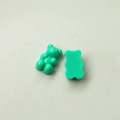 Flat lay of green resin gummy bear DIY accessories with smooth flat back for phone cases - Green