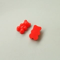 Detail of two red resin bear charms showing front and flat back for DIY crafts - Red
