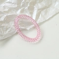 Close-up of pink spiral resin hair coil with flexible spring texture for DIY accessories - Pink