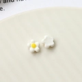 Macro shot of white daisy resin flower accessories for DIY nail art and jewelry making - Milk White