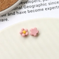 Detailed close-up of matte pink acrylic sunflower DIY accessories on a ceramic plate - Pink