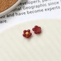 Macro shot of red floral resin nail art charms and DIY jewelry accessories - Burgundy