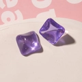 Close-up of square purple jelly resin studs with glitter inside on a white tray - Purple