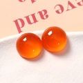 Macro-opname van glanzende oranje hars cabochons voor DIY-sieraden en accessoires - 1 Stuk / Oranje