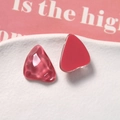 Macro shot of pink resin charms with unique water ripple texture and smooth finish - Red
