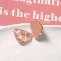 Macro shot of triangular resin charms with water ripple texture in warm nude pink - Pink