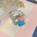 Detail of creative resin ring featuring a cute pink and blue bear on transparent band - Tiffany Blue