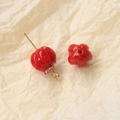 Macro shot of red pumpkin-shaped glass beads with gold pins for DIY jewelry making - 1 Piece / Red