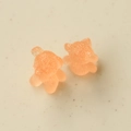 Macro view of 3D resin bear charms with translucent orange texture for DIY crafts - Orange