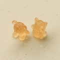 Macro detail of amber resin 3D bears with textured fur for DIY jewelry making - Tan
