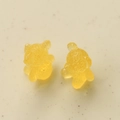 Close-up of translucent yellow resin bear charms with detailed texture for DIY crafts - Yellow