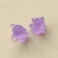Close-up of two purple translucent resin cat charms with 3D texture for DIY crafts - Purple