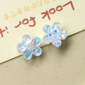 Detail of DIY flower charms with blue sequins inside transparent resin material - White