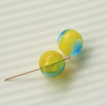 Macro shot of 16mm gradient glass beads on a gold pin for DIY jewelry making accessories - Yellow And Blue Swirl Style (40#1)