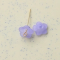 Macro shot of frosted translucent lavender flower charms for DIY jewelry making - Purple
