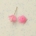 Macro shot of semi-transparent pink frosted flower resin charms with gold metal needles - Rose Red