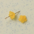 Macro detail of translucent frosted orange flower resin charms for DIY jewelry making - Ginger Yellow