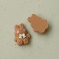 Detailed view of cute brown resin bunny charms with white bows for DIY jewelry and crafts - Coffee Rabbit