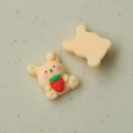 Detailed macro view of yellow resin cartoon rabbit with strawberry and smooth flat back - Yellow Rabbit with Strawberry