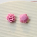 Macro detail of pink resin rose flower charms showing front petals and flat back base - Rose Red