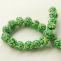 Macro detail of round glass beads with floral patterns in green, yellow, and white colors - 1 Piece/Pack / Dark Green