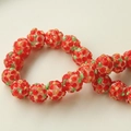 Detailed macro view of handmade 3D floral glass beads with red petals and green leaves - 1 Piece/Pack / Red