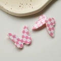 Macro view of butterfly resin charms with pink and white checkerboard pattern texture - Checkerboard Butterfly / Pink