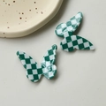 Detailed view of green and white checkered resin butterfly accessories with glossy finish - Checkerboard Butterfly / Green