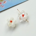 Detail of translucent glass flower beads with silver flakes and vibrant orange pistils - 1 Piece / Clear White