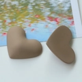 Macro detail of 3D heart-shaped matte resin charms in brown for DIY jewelry making - Brown Heart
